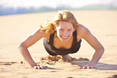 Young fit girl doing push ups clipart