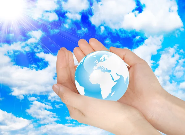 Hands holding earth in the sky — Stock Photo, Image