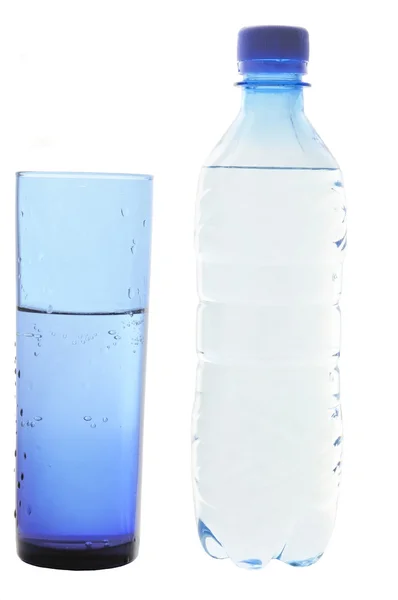 Mineral water in a glass and bottles — Stock Photo, Image