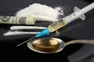 Drugs. Cocaine, money, syringe and spoon. clipart