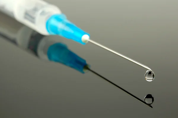 Syringe with a drop — Stock Photo, Image
