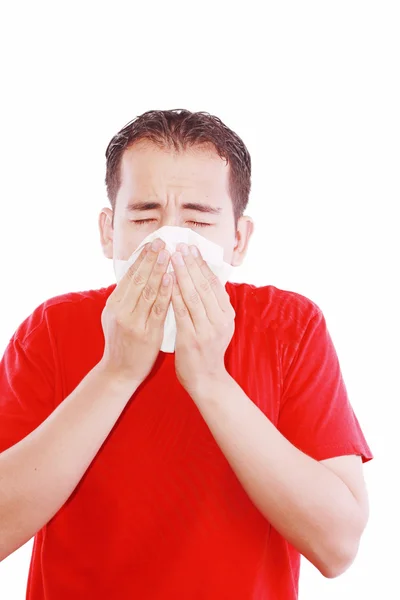 Young man with a cold blowing nose on tissue — Stock Photo, Image