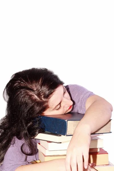 Joven hermosa mujer durmiendo con libros en un fondo blanco —  Fotos de Stock