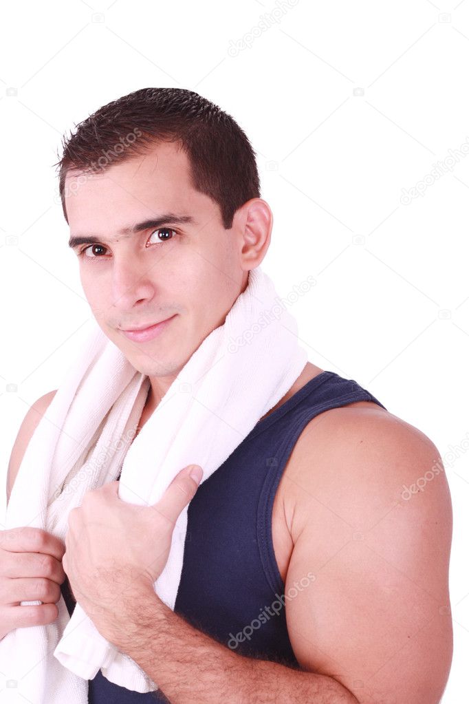 A young man just finishes his workout and with towel over his shoulder