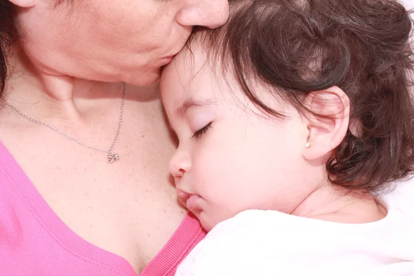 Kvinna med sovande baby Royaltyfria Stockfoton
