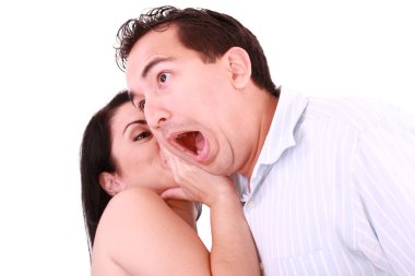 Woman tells something into surprised guy's ear isolated on white clipart
