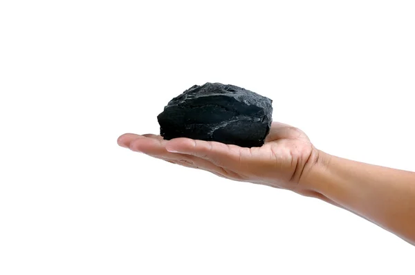 Männliche Hand hält einen kleinen Klumpen Kohle — Stockfoto