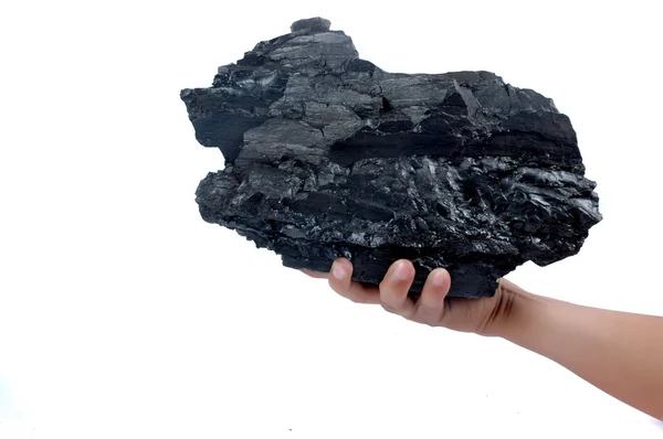 Мужская рука держит большой кусок угля — стоковое фото
