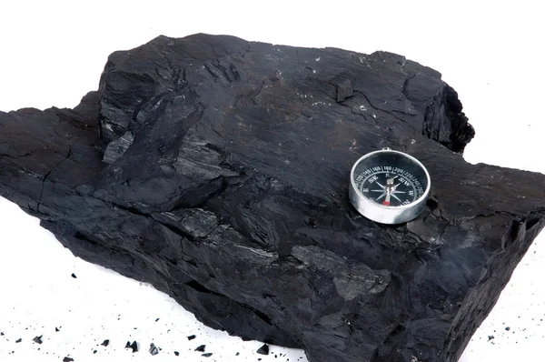 A lump of coal and compass — Stock Photo, Image