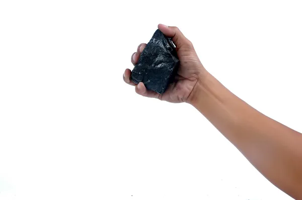 Männliche Hand hält einen kleinen Klumpen Kohle — Stockfoto