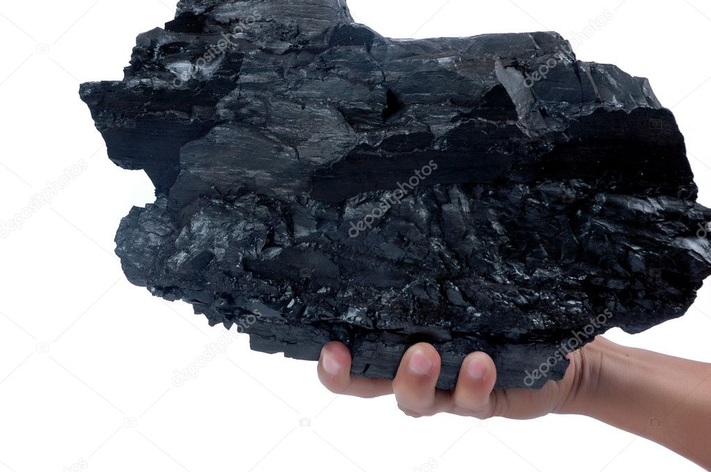 Male hand holding a big lump of coal
