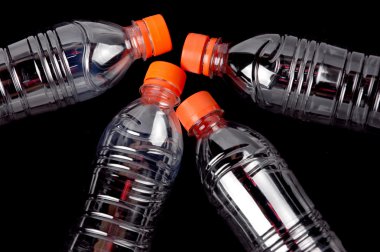 Four closed plastic bottles