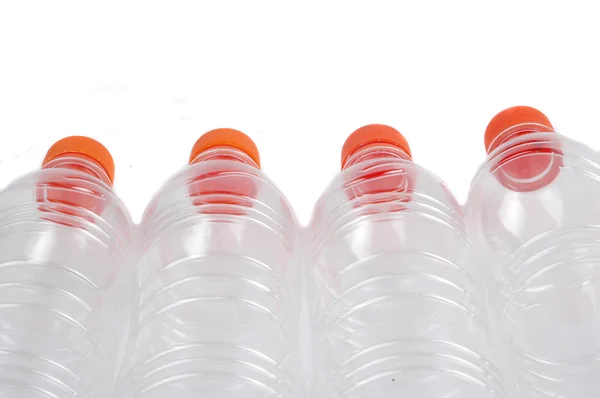 Four closed plastic bottles — Stok fotoğraf