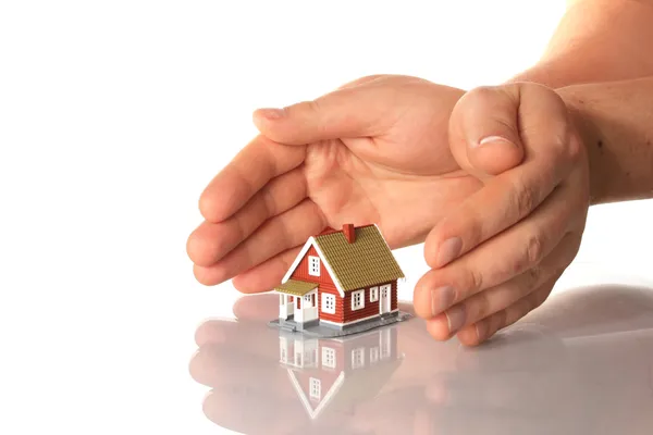Hands and little house. — Stock Photo, Image