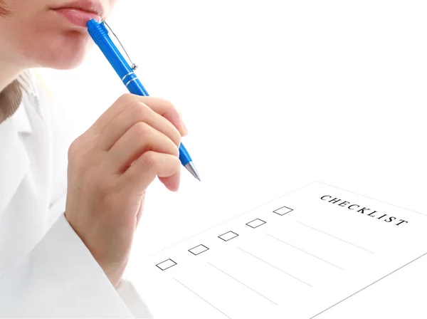 Female doctor is filling checklist. — Stock Photo, Image