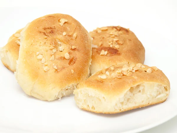 Four fresh home baked buns with chopped nuts