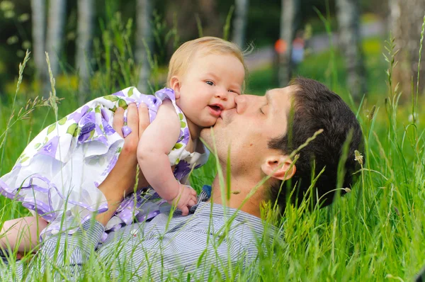 stock image Happy father with daughter resting in the grass