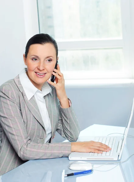 Attraente sorridente giovane donna d'affari utilizzando il computer portatile — Foto Stock