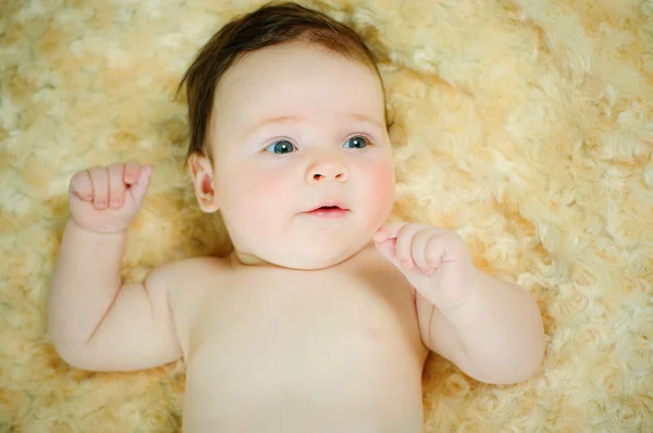 Beautiful baby boy is lying in a bed. — Stock Photo, Image