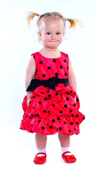 Roztomilá holčička v červených šatech. ve studiu. samostatný — Stock fotografie