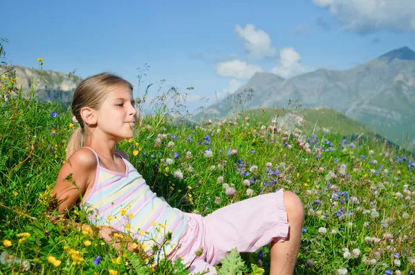 Girl lying in a meadow backround Alps — Stock Photo, Image