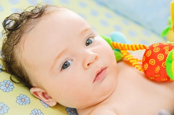 Beautiful baby boy is lying in a bed. — Stock Photo, Image