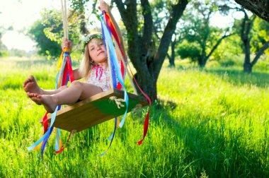 Young girl on swing clipart