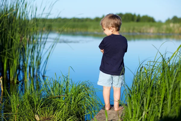 Boy near the river — Stock Photo, Image