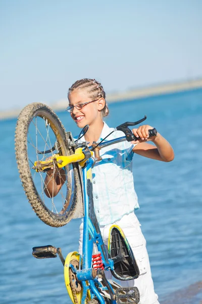 Belle jeune fille debout avec son vélo — Photo