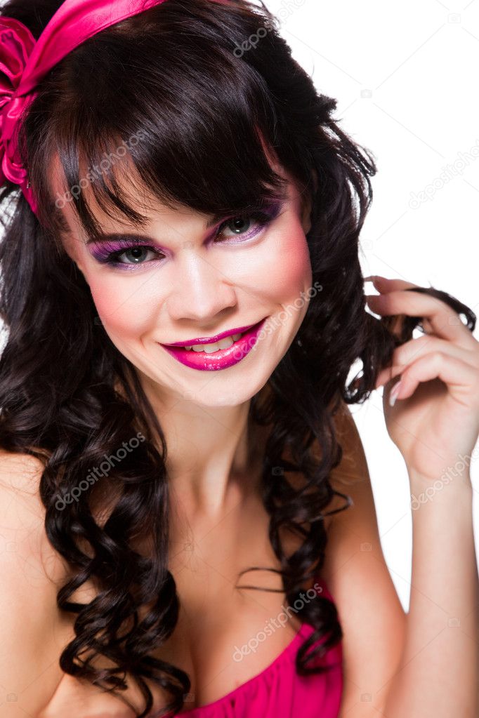 Portrait of beautiful girl with dark hair wearing pink on white