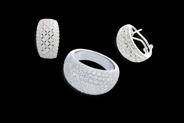 stock image Jewelery of white gold with brilliants on isolated bkack