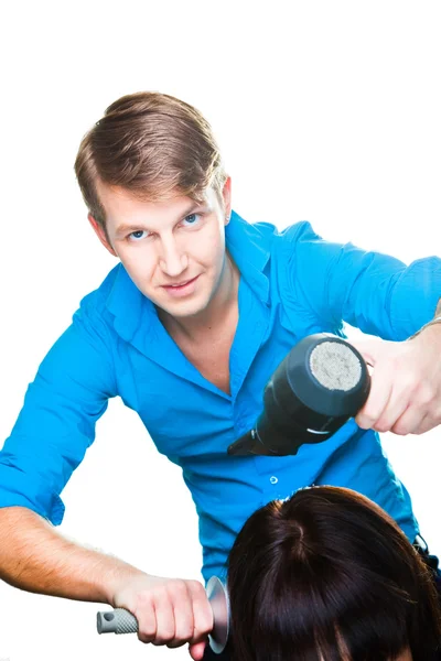 Coafeză om de lucru cu uscător de păr pe alb izolat — Fotografie, imagine de stoc