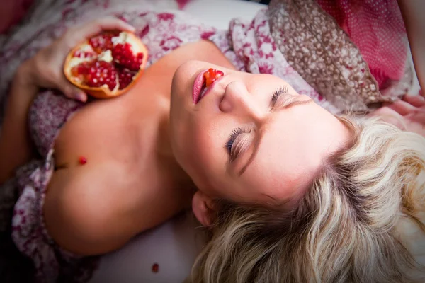 Lying woman with pomegranate — Stock Photo, Image