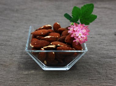 Almond and flowers in the glass square bowl clipart