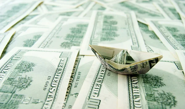 Ship made of money in sea of dollar notes — Stock Photo, Image