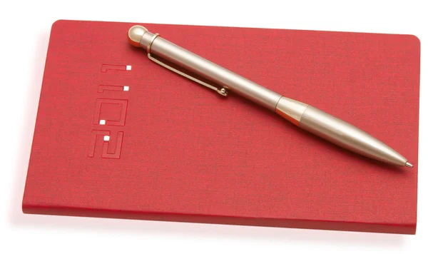 Красная тетрадь и ручка — стоковое фото