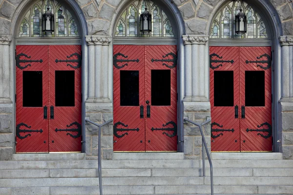 stock image Three red doors in stone building