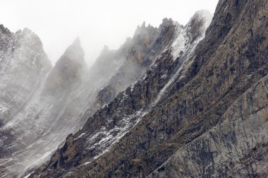 Rugged mountains in the winter fog clipart