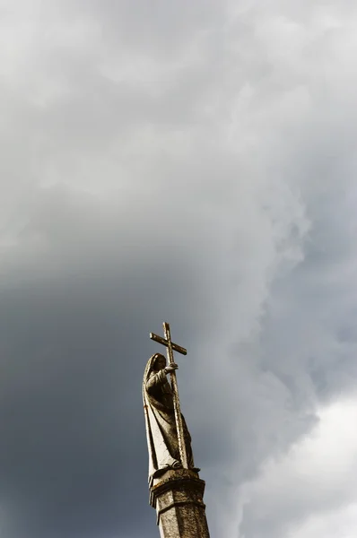 Saint holding a cross — Stock Photo, Image