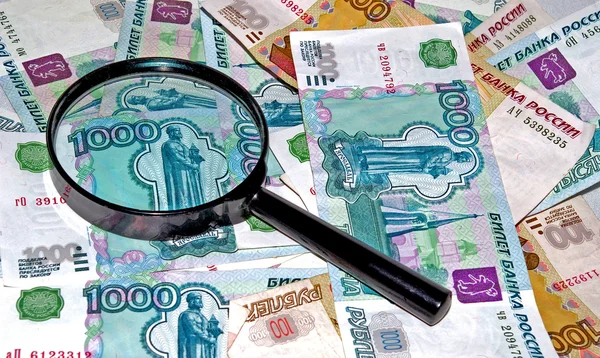 Money under magnifying glass — Stock Photo, Image