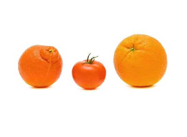 Мандарин, помидор и апельсин крупным планом на белом фоне — стоковое фото