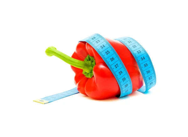 Red pepper and a measuring tape on white background — Stock Photo, Image