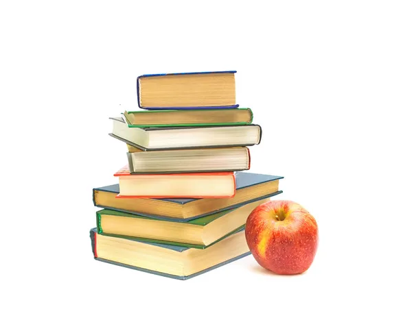 Großer roter Apfel und Bücher auf weißem Hintergrund — Stockfoto