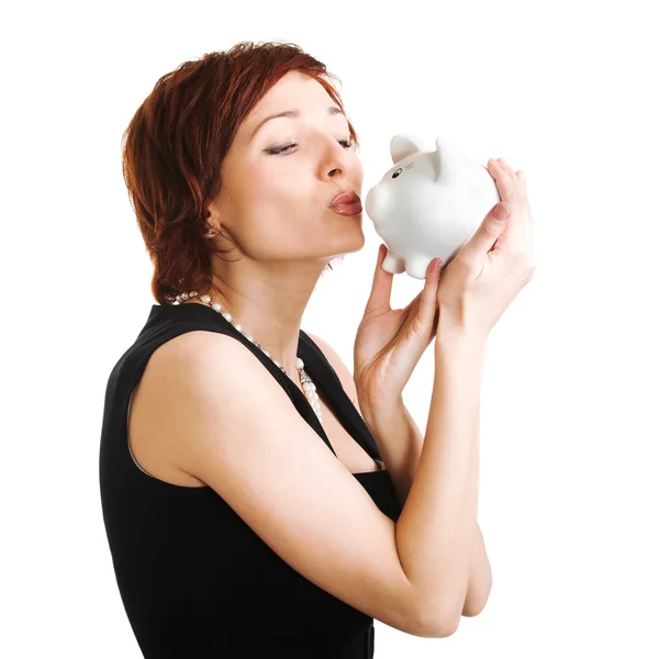 Woman holding piggy bank against white background — Stockfoto