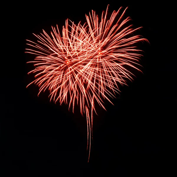 Fogos de artifício vermelhos brilhantes no céu noturno na forma de coração — Fotografia de Stock