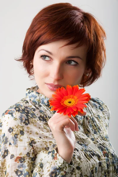 Beautiful woman with flower in her hands — Stock Photo, Image