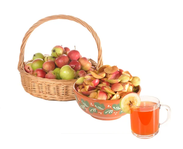 Apples in a basket, slices of apples and a juice glass — Stock Photo, Image