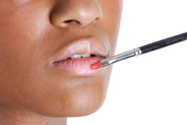 stock image Young woman applying a lip brush