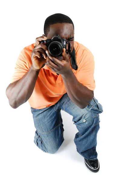Student photographer kneeling to take a picture — Stock Photo, Image
