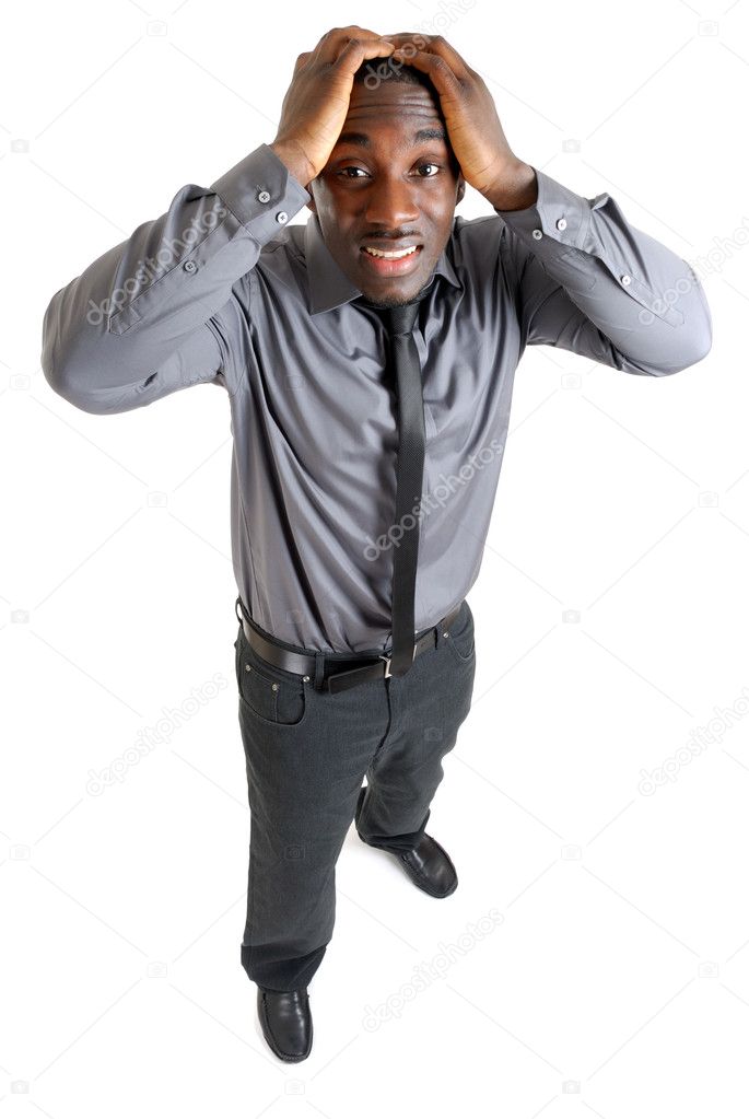 Businesss man with hands on his head due to failure